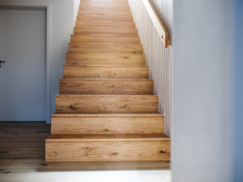 a-wooden-staircase-and-white-wall-in-an-interior-o-2023-11-27-04-55-48-utc_low.png